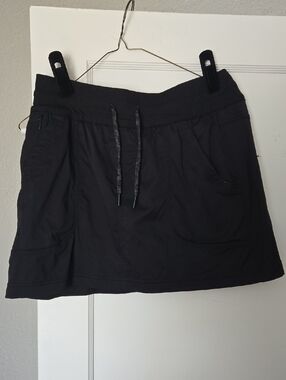 The North Face Casual Drawstring Skirt in Black With Mesh Shorts Underneath